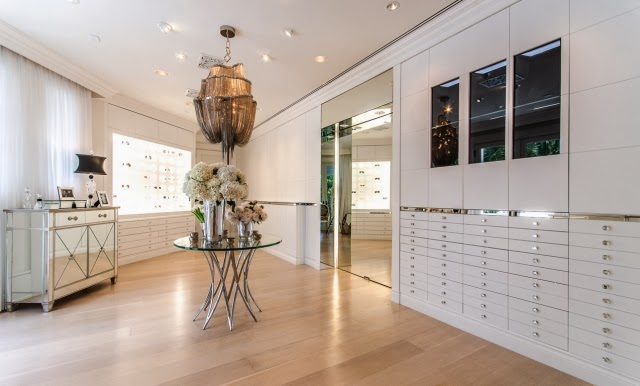 Walk in closet/dressing room in Celine Dion's home with mirrored dresser and built in storage