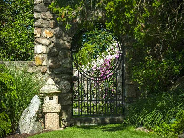 Stone wall iron garden gate at Copper Beech Farm
