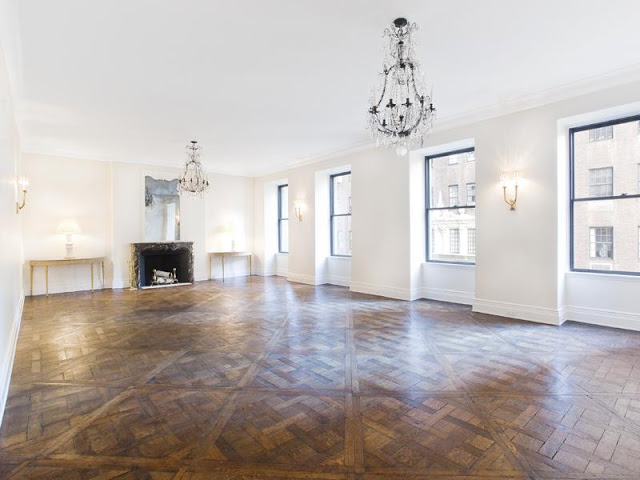 Living room with parquet wood floors, chandeliers and a fireplace 