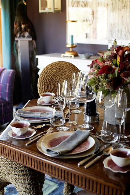 close up of the dining room table settings and wicker chairs