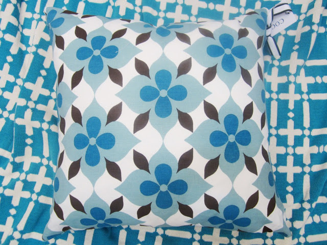 COCOCOZY Coco's Flower cotton pillow in blue and brown on a peacock blue COCOCOZY Plaid Solid Throw