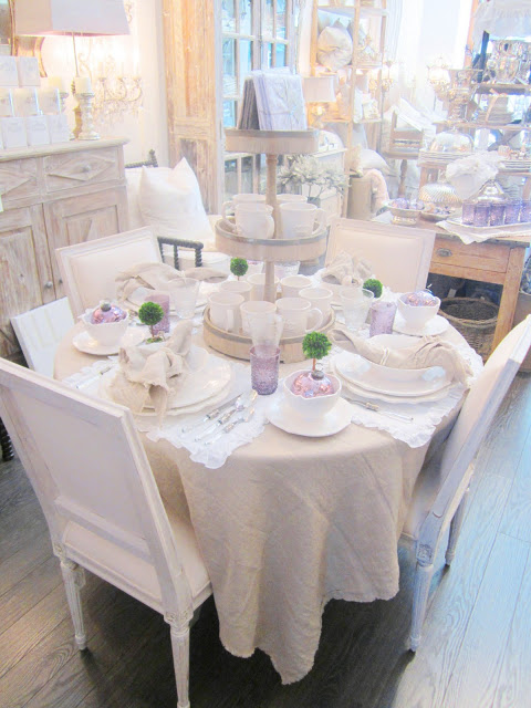 Pom Pom table setting with linen napkins and table clothes and lavender glasses