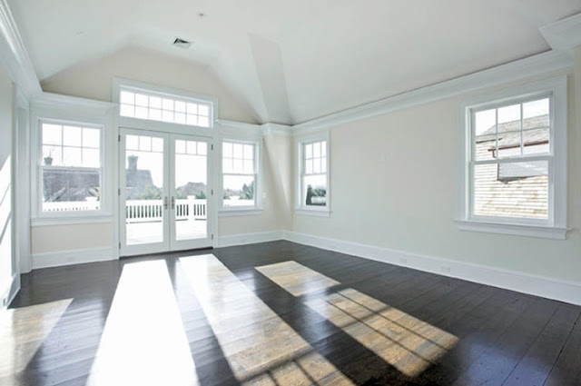 empty bedroom with wood floors and large windows