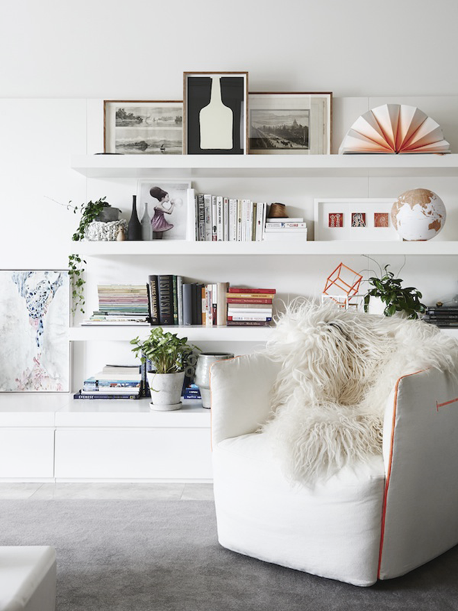 White living room with floating shelves