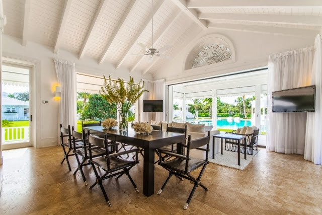 Informal dining room in Celine Dion's home with a view of the pool and backyard