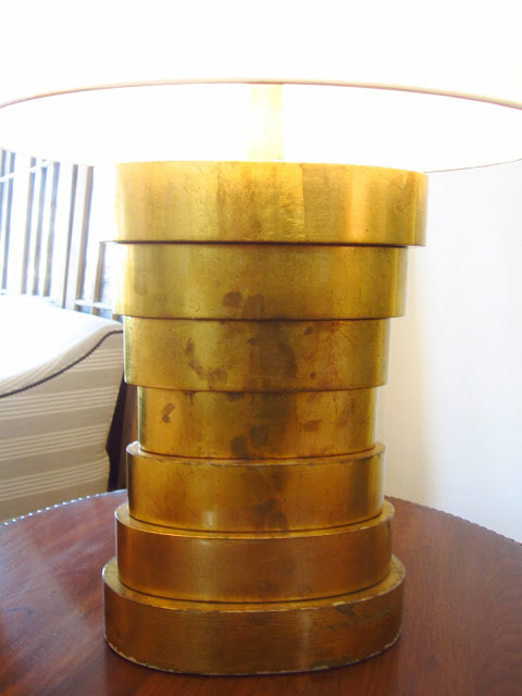 Close up of the stacked, circle base on a brass table lamp
