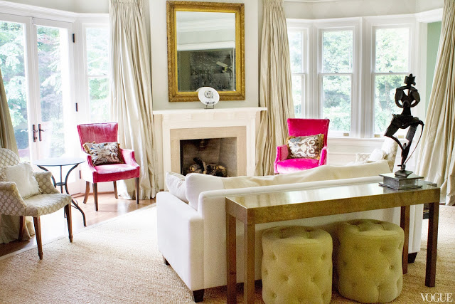 Living room of Vogue.com contributor Sophie Young's childhood home in Toronto with mint walls, wood floor, white sofa, gold framed mirror and pink chairs