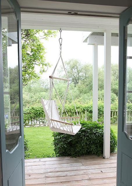 backyard patio with woven porch swing 