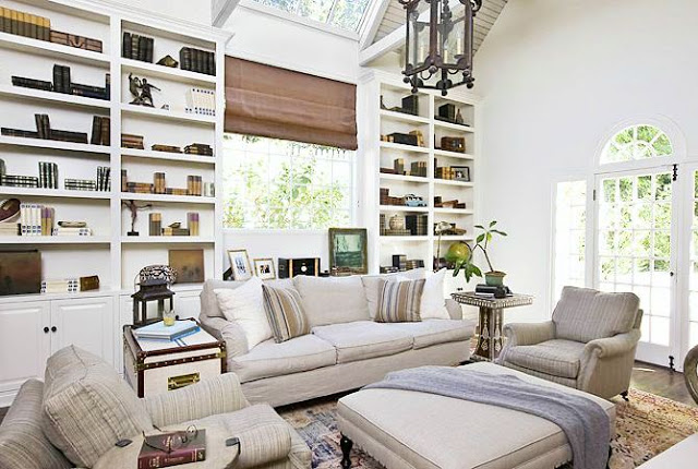 Traditional living room with built in bookcase, sofa, ottoman and dueling armchairs