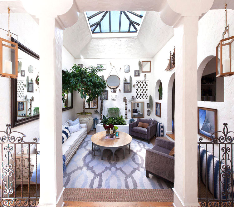 eclectic living room with skylight and lots of mirrors
