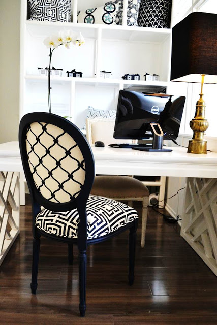 COCOCOZY HQ office space with a vintage brass Stiffel lamp sitting on a White Laquer Fertwork Parsons Desk, navy Louis chair with COCOCOZY Logo linen on the front and COCOCOZY Fence in navy on the back