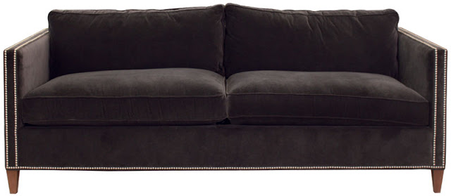 Grey velvet sofa with exposed legs