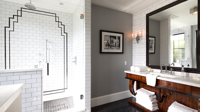 Guest bathroom grey walls floor to ceiling white subway tiles black art deco motif in shower wood cabinets