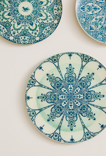 Blue and white plates being used as wall decor