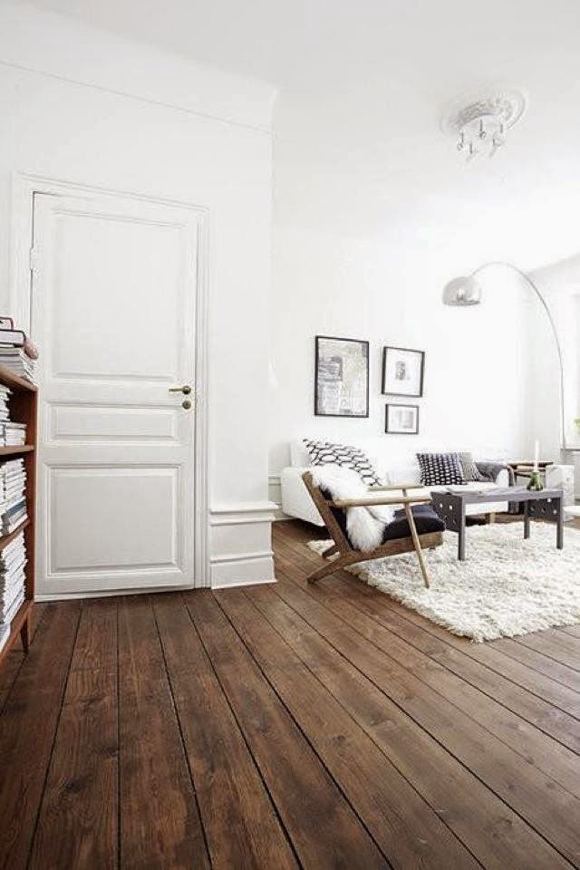 White living room with rustic wood floor