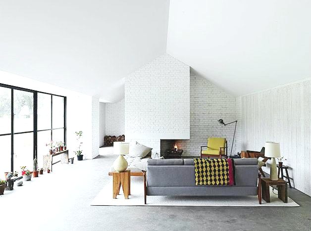 living room white brick fireplace modern decor large sliding glass doors bright interior