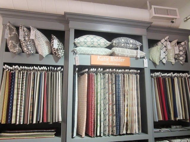 COCOCOZY pillows in cubbies above designer Katie Ridder's textile collection
