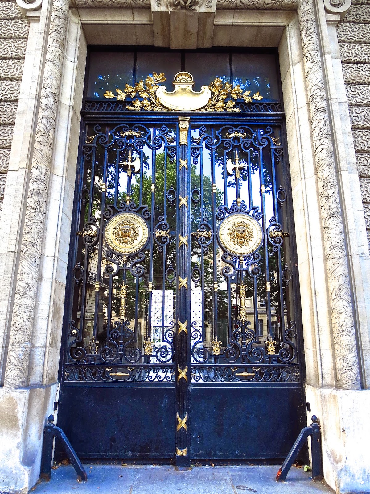 Metal and glass door in Paris with gold medallions