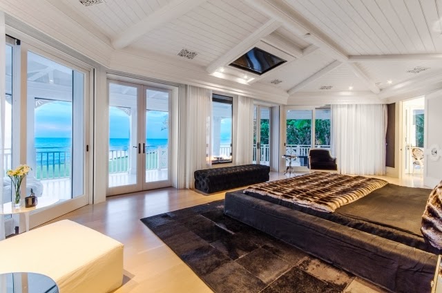 Bedroom in Celine Dion's home with a view of the ocean, a grey bed and matching rug