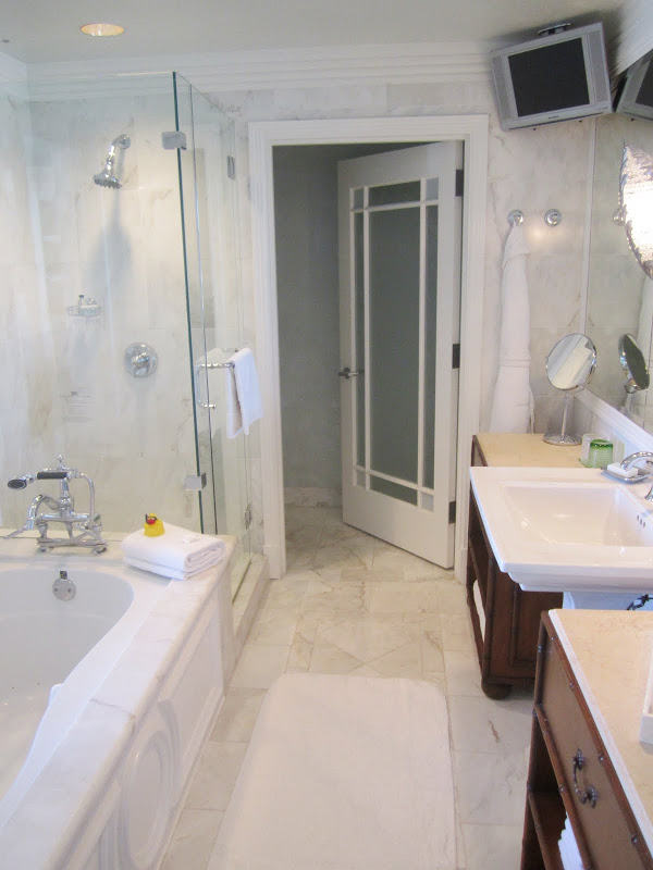 marble bathroom at Casa del Mar with a step in tub, pedestal sink and a TV