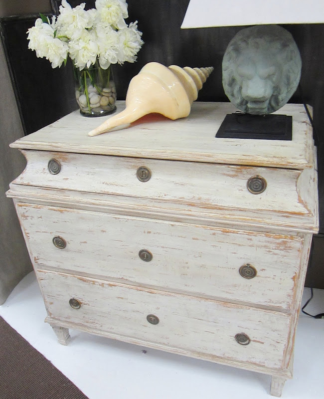 Swedish 3 Drawer Chest by Tara Shaw Maison with a large sea shell, flower arragement and lion portrait