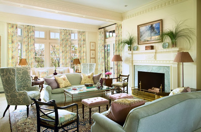 Living room in a South Carolina estate with light blue dueling sofa, a blue and white arm chair and lavender upholstered ottomans
