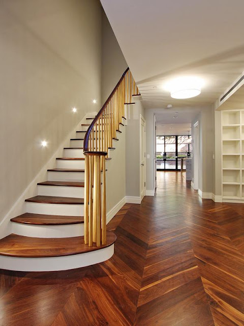 First floor foyer and stairs with herringbone wood floors