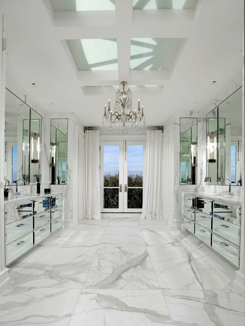 master bathroom with marble floor, mirrored cabinets and drawers, crystal chandelier, french doors and skylight