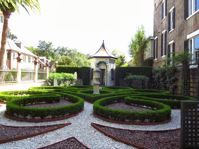 Manicured garden with trimmed boxwoods and crushed gravel in Charleston, South Carolina