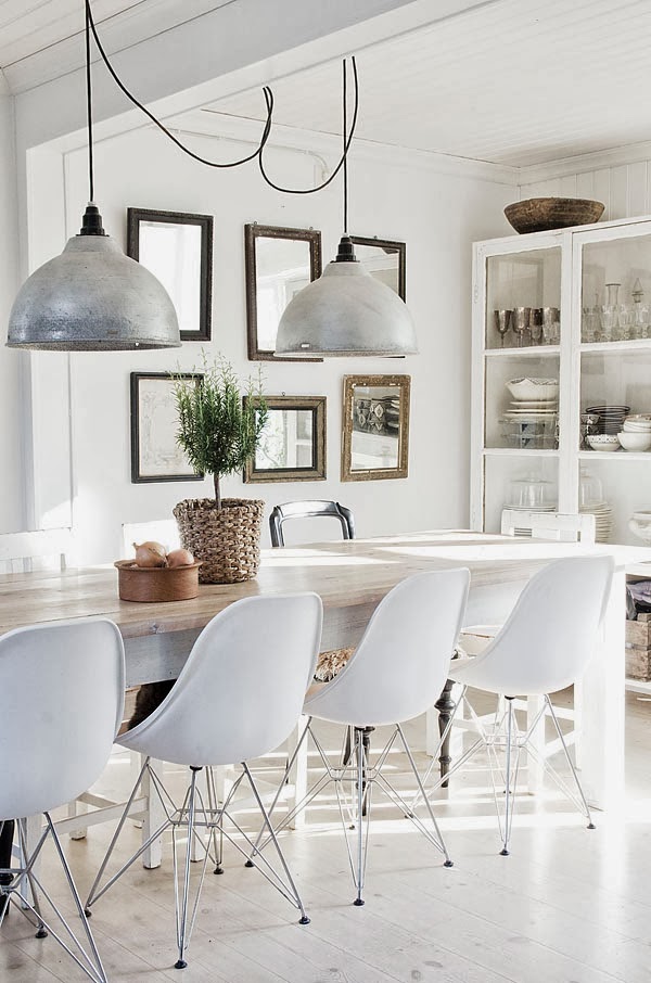 White dining room with Eames chairs and a long table