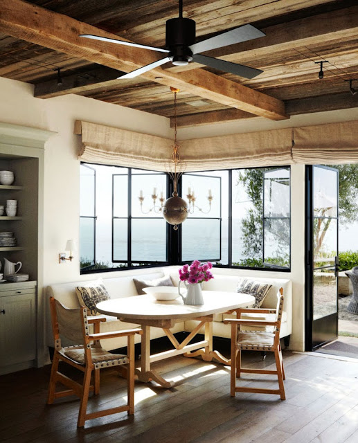 Breakfast nook with exposed beams and built in banquette seating