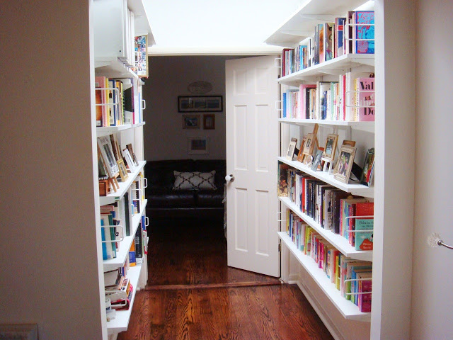  After replacing the honey colored open shelving bookshelves with white ones to brighten the space