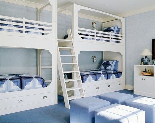 two sets of white bunk beds with one ladder in a blue room