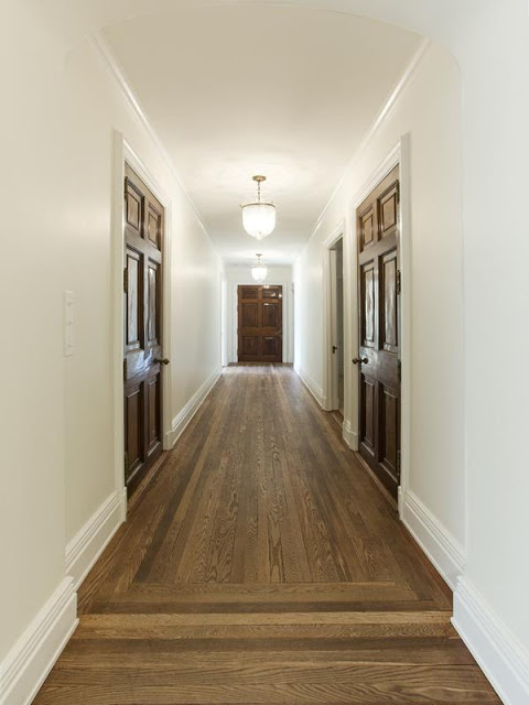 hallway with wood floor and white walls