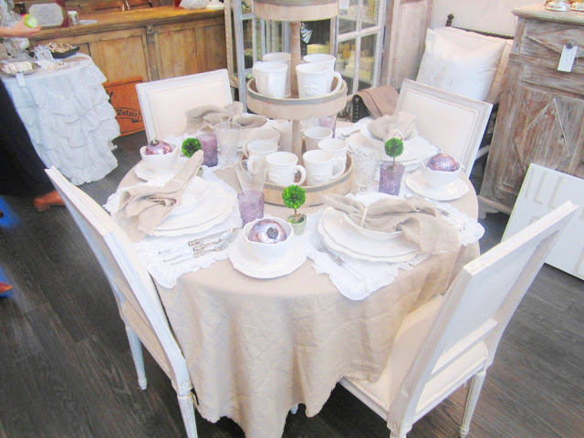 Pom Pom table setting with linen napkins and table clothes and lavender glasses