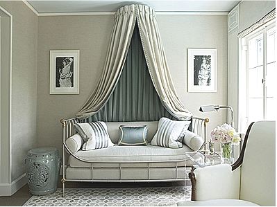 Silver guest bedroom with decorated molding, a crown canopy over an iron day bed with silver accent pillows, a lucite side table holding a silver lamp and a grey Chinese garden stool