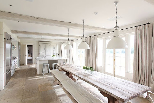 open kitchen with extra long dining room table, bench seating, french doors, floor length curtains, and three pendant lights