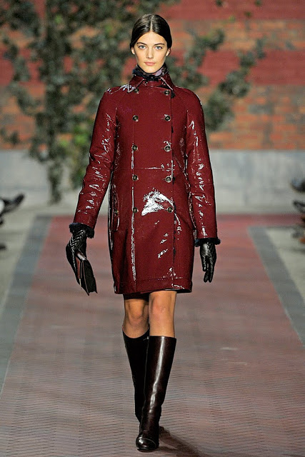 model from tommy hilfiger's fall 2012 runway show wearing an oxblood patent leather pea coat with burgundy flat knee high boots