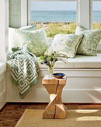 Close up of the COCOCOZY throw in a window seat vignette with an ocean view in the Coastal Living Magazine