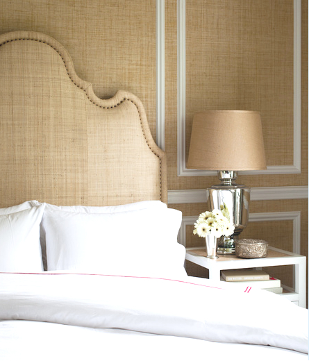Bedroom with Seagrass walls, raffia headboard and white nightstand with raffia accents