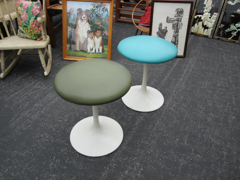 Two Saarinen inspired stools with a white tulip base and vinyl seat cushions