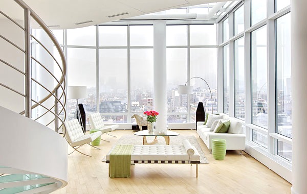 New York duplex penthouse with wood floors, white sofas and an amazing view of the city