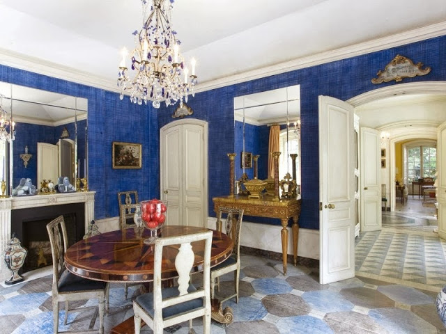 Traditional blue dining room in a NYC townhouse with painted floors, a crystal chandelier and antique round inlaid table
