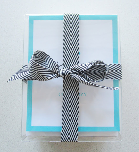 COCOCOZY holiday stationery wrapped in a black and white ribbon