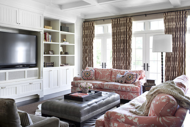 T.V. Room with Palm Beach style fabric upholstered sofas and a large leather ottoman.