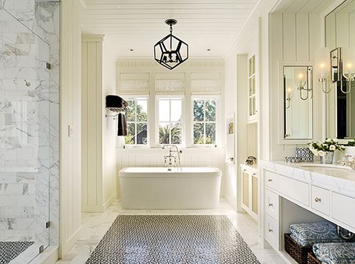 Bathroom with stand alone porcelain tub, marble floor, carpet mosaic tile and a black decahedron pendant light