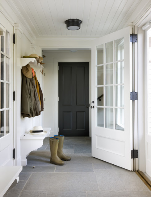 boots on a store floor in a mudroom with white paneled ceiling