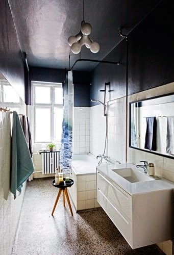 Bathroom with pebble tile floor and black accents