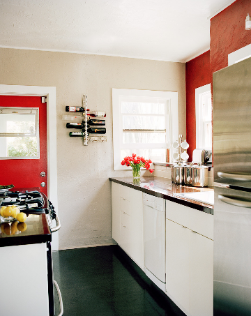 small kitchen white cabinets red door accent wall black floor counters interior design wall wine rack cococozy