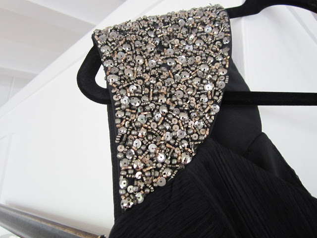 Close up of the shoulder on navy silk beaded one shoulder Carlos Miele gown